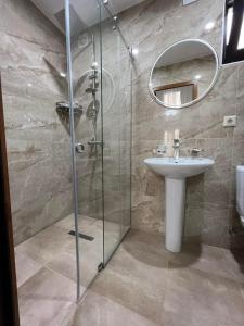 a bathroom with a shower and a sink and a mirror at villa with beautiful view 2 in Tbilisi City