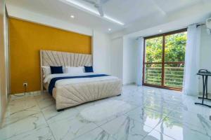 a bedroom with a bed and a yellow wall at Sedra home@Aqua apartments in Mombasa