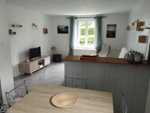 a living room with a table and a window at appt F3 - La Bresse/Cornimont in Cornimont