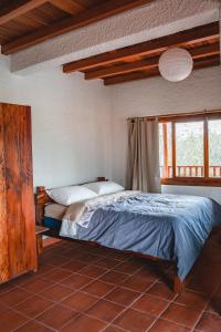a bedroom with a bed in a room at Vistabamba Ecuadorian Mountain Hostel in Vilcabamba