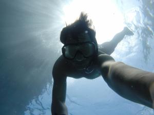 a person swimming in the water in the water at RESOL Secluded Ocean-view luxury in the Jungle in Uvita