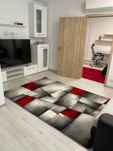 a living room with a red and black carpet at Byteček v přízemí . ( Apartment no.17 ) in Znojmo