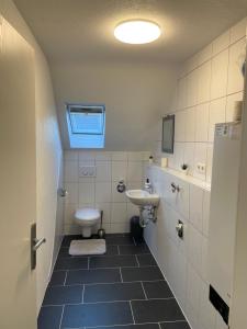 a small bathroom with a sink and a toilet at Ferienwohnung Rastatt in Rastatt