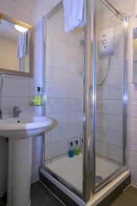 a bathroom with a shower and a sink at Escape to a Clifftop Chalet with pool and tennis onsite - 38 Kingsdown Park in Kingsdown