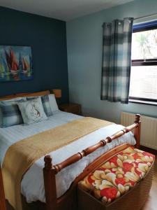 a bedroom with a bed and a window at Lynn's Lodge in Randalstown