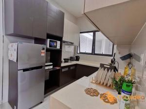a kitchen with a refrigerator and a counter top at Hotpot In the Sky - RiverView In City by Cowidea in Johor Bahru