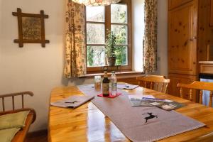a dining room table with a bottle of wine on it at Peter - a87525 in Mittenwald