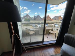 a room with a large window with chairs and a patio at Bello depto full equipado in Los Ángeles