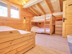 a bedroom with two bunk beds in a wooden cabin at Chalet Notre-Dame-de-Bellecombe, 6 pièces, 12 personnes - FR-1-505-99 in Notre-Dame-de-Bellecombe