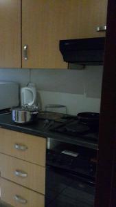a kitchen with a stove and a counter top at Rona Thina House in Pimville