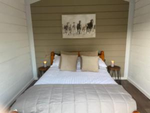 a bedroom with a white bed with two candles at The Haystack in Oswestry