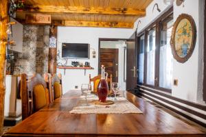 a table with wine glasses and a bottle on it at Koliba Ravna planina in Pale