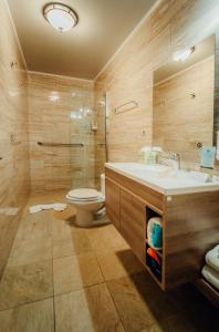 a bathroom with a sink and a toilet at RH Boutique Hotel Aruba in Oranjestad