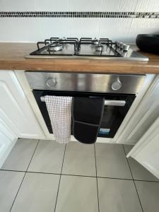 a kitchen with a stove and a sink at Holiday Home Cardiff City Sleeps 7 in Cardiff