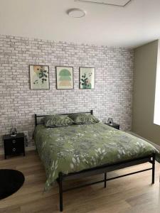 a bedroom with a bed and a brick wall at Maison individuelle in Vincey