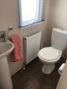 uma casa de banho com um WC branco e um lavatório. em 20 The Green em Jedburgh