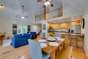 a kitchen and living room with a table and a blue couch at Waterfront Hartfield Vacation Rental with Dock! in Hartfield