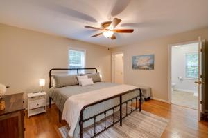 a bedroom with a bed and a ceiling fan at Waterfront Hartfield Vacation Rental with Dock! in Hartfield +33 photos