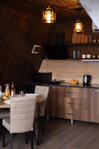 a kitchen with a table and chairs and a counter at UkhutiEcoHouse in Vani