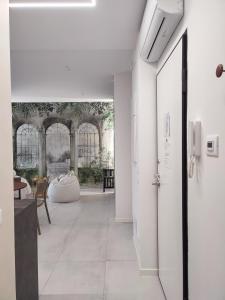 a hallway with a door and a table and chairs at AL PONTE design apartment in Conegliano