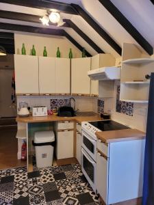 a kitchen with white cabinets and a stove top oven at Craighlaw Arms Boutique Hotel B&B in Kirkcowan