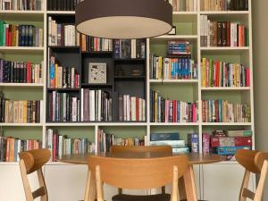 a dining room with a book shelf filled with books at Apartments in Valmiera in Valmiera