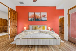 a bedroom with an orange wall and a bed at Sedona Family Vacation in Sedona +48 photos