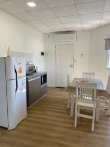 a kitchen and dining room with a refrigerator and a table at Complejo 599 in San Luis