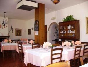 a restaurant with tables and chairs with white tablecloths at Agriturismo La Cavaliera in Monteveglio