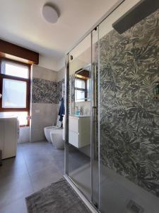 a bathroom with a shower and a sink and a toilet at Casa Lariana in Lecco