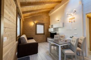 a kitchen and dining room with a table and chairs at Ivan House in Livigno