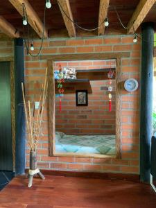 a brick wall with a mirror on it at Rancheria Loft Chalet, lago privado in Rionegro