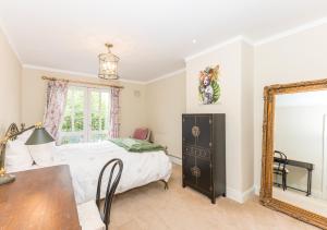 a bedroom with a bed and a mirror and a table at Fashionable Chic Townhouse in D4 in Dublin