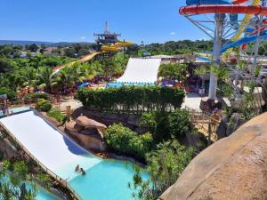 an image of a water park with a roller coaster at Piazza Diroma - Com acesso Acqua park CN-GO in Caldas Novas