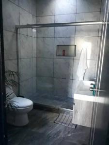 y baño con ducha, aseo y lavamanos. en Casa Hogareña las estacas 