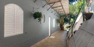 an alley with white walls and white shuttered windows at Casa do Mirante in Petrópolis