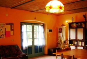 a living room with a table and a window at B&B Locanda della Sesta Felicità in Vaglio Serra