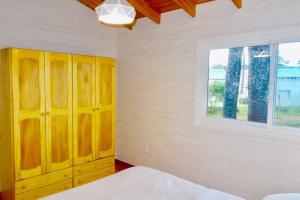 - une chambre avec une armoire jaune et une fenêtre dans l'établissement Klimatisiertes Haus am Meer in Chihuahua, à Punta del Este