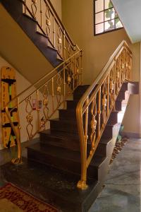 a stairway with a wrought iron railing in a house at DUO BOUTIQUE HOTEL in Medellín