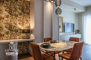 a dining room with a table and chairs at Visconti 46 Central Apartments in Bari