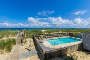 an image of a swimming pool with the ocean in the background at 5732 - Beach Music in Nags Head