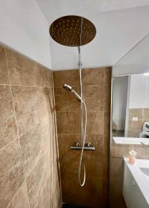 a shower with a shower head in a bathroom at Apartamento céntrico el Médano in El Médano