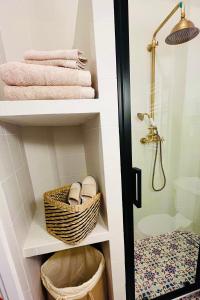 a bathroom with a shelf with a basket and towels at CHEZ TAMARA in Nice