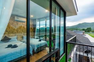 a bedroom with a bed on a balcony at White Cloud & Brown Sand Luxury Pool Villa Cha-Am in Cha Am