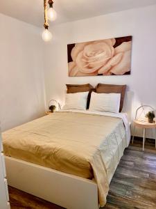 a bedroom with a large bed with a painting on the wall at Apartamento céntrico el Médano in El Médano