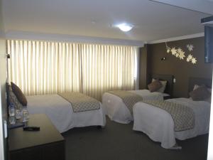 Postel nebo postele na pokoji v ubytování Hotel Novalux