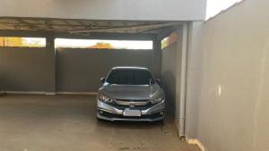 a silver car parked in a garage at Apartamento Daia Prox Caoa in Anápolis