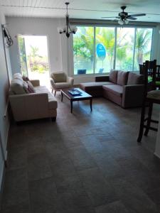 a living room with couches and a coffee table at Beautiful oceanfront townhouse LA Barqueta Nice Las Olas resort in Guarumal