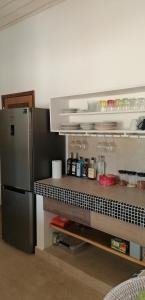 a kitchen with a refrigerator and a counter with food at Villa Blue in Boukot Ouolof