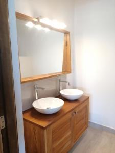 a bathroom with two sinks and a mirror at Villa Blue in Boukot Ouolof